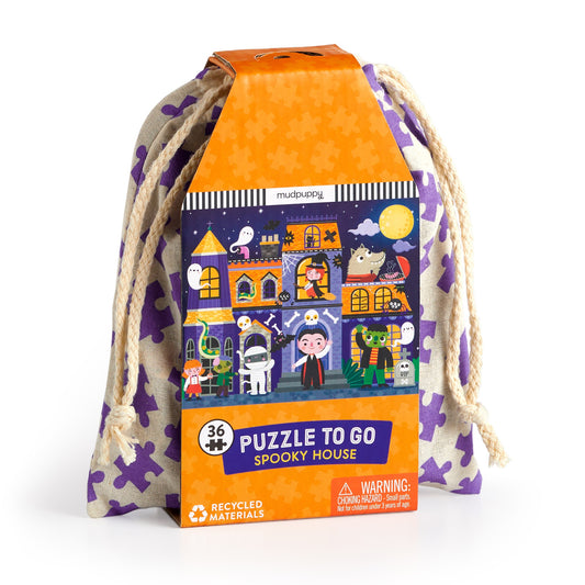 The Liv Wan Spooky House 36 Piece Puzzle to Go features cartoon Halloween monsters and ghosts in orange, purple-accented drawstring packaging—perfect for kids who love fun, spooky challenges!.