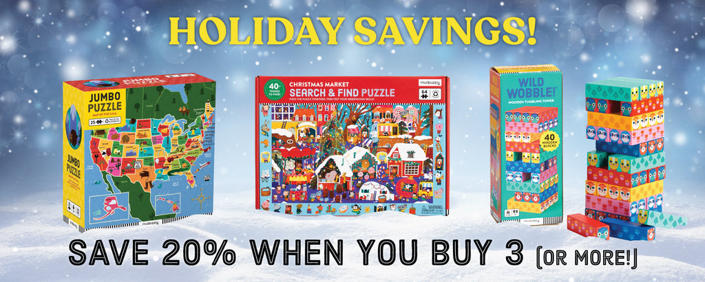 A holiday sale banner displays three colorful children’s puzzles and games with festive backgrounds. Text reads: HOLIDAY SAVINGS! SAVE 20% WHEN YOU BUY 3 (OR MORE!).