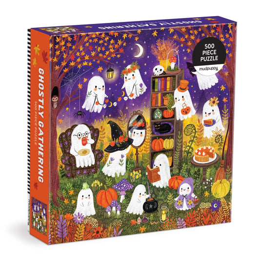 The Jenny Miriam Ghostly Gathering 500 Piece Family Puzzle features cheerful ghosts at a festive night party with pumpkins, food, candles, books, and colorful autumn trees—perfect for family fun!.