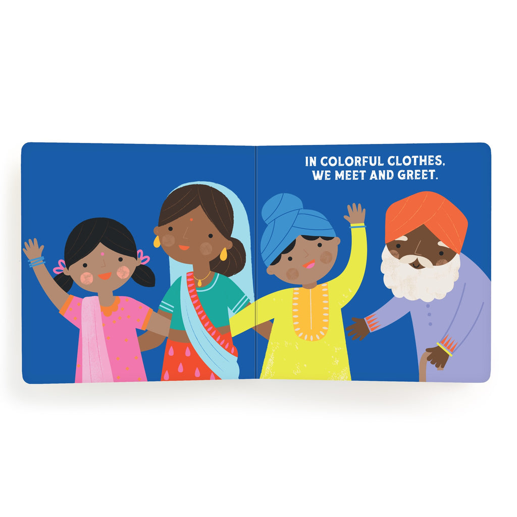 Illustration of four people in colorful traditional clothing waving, with the text In colorful clothes. We meet and greet. on a blue background—perfect for Lets Celebrate Diwali Board Book by Nina Ghataora.