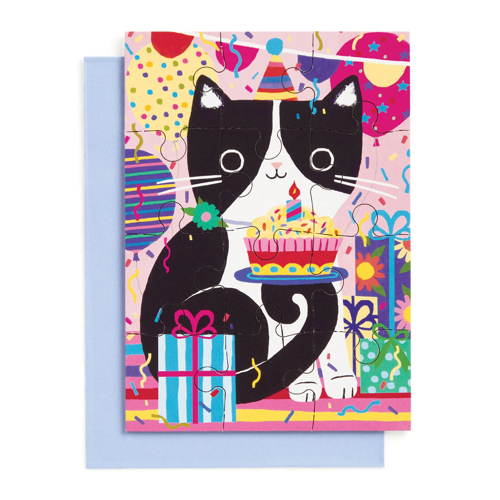 The Purr-fect Cat Birthday Greeting Card Puzzle by Tara Lilly features a festive black and white cat in a party hat with a cupcake, gifts, and balloons—an ideal choice for any feline-loving friend!.