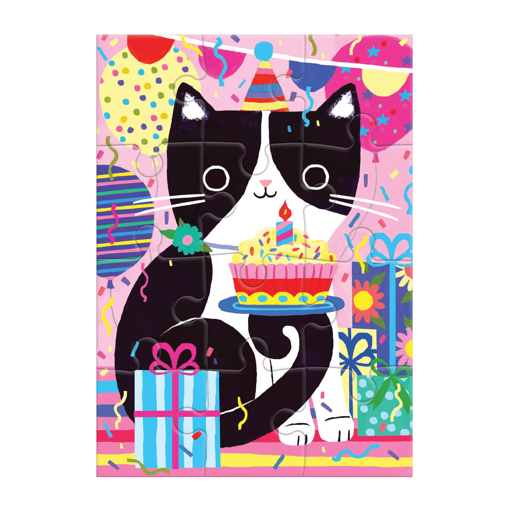 A black and white cartoon cat in a party hat sits among presents and balloons, holding a cake on this festive Purr-fect Cat Birthday Greeting Card Puzzle by Tara Lilly, set against a pink backdrop with confetti and streamers.