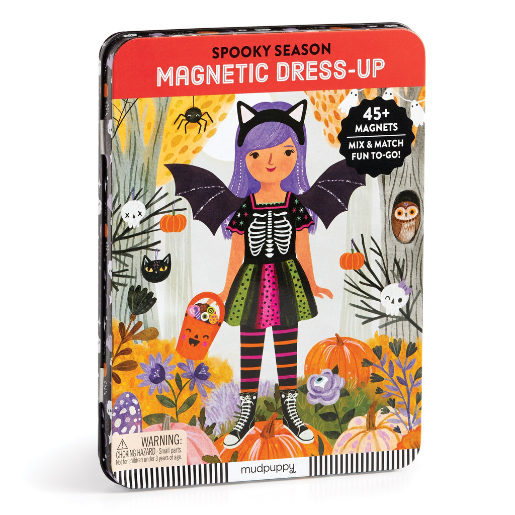 The Spooky Season Magnetic Dress-up Play Set by Jenny Miriam Hughes comes in a colorful tin with a cartoon girl in a bat costume, pumpkins, and animals. It includes 45+ magnets for imaginative play.