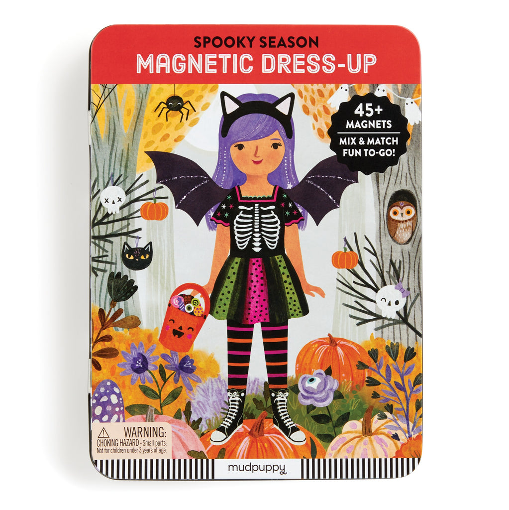 The Spooky Season Magnetic Dress-up Play Set by Jenny Miriam Hughes features a girl in a skeleton costume with bat wings, autumn leaves, pumpkins, and animals. With over 45 magnets, it encourages imaginative play throughout the season.