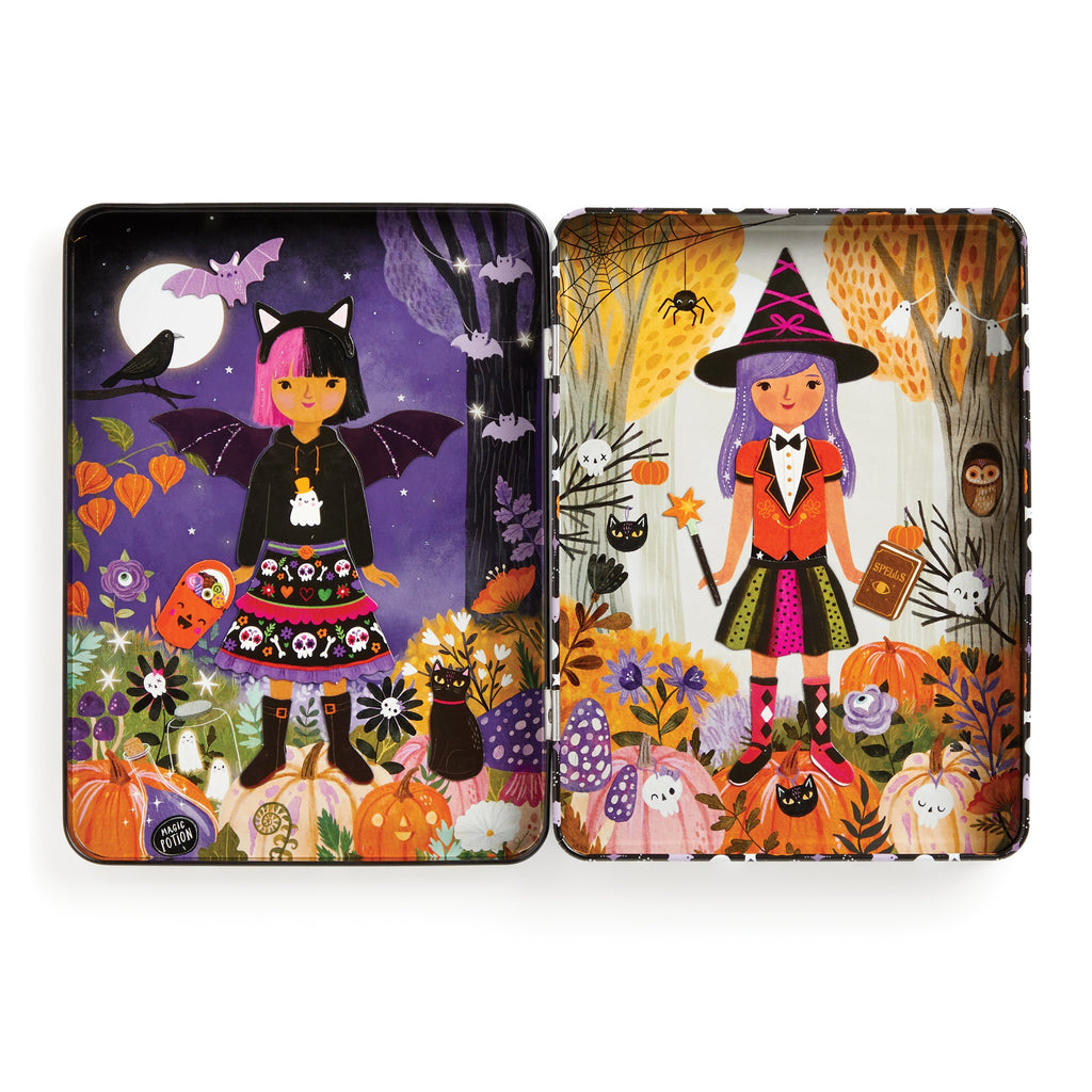 The Jenny Miriam Hughes Spooky Season Magnetic Dress-up Play Set features two illustrated trays: one with a girl in a bat costume at night, the other as a witch by day, both surrounded by pumpkins, cats, and autumn foliage for imaginative play.