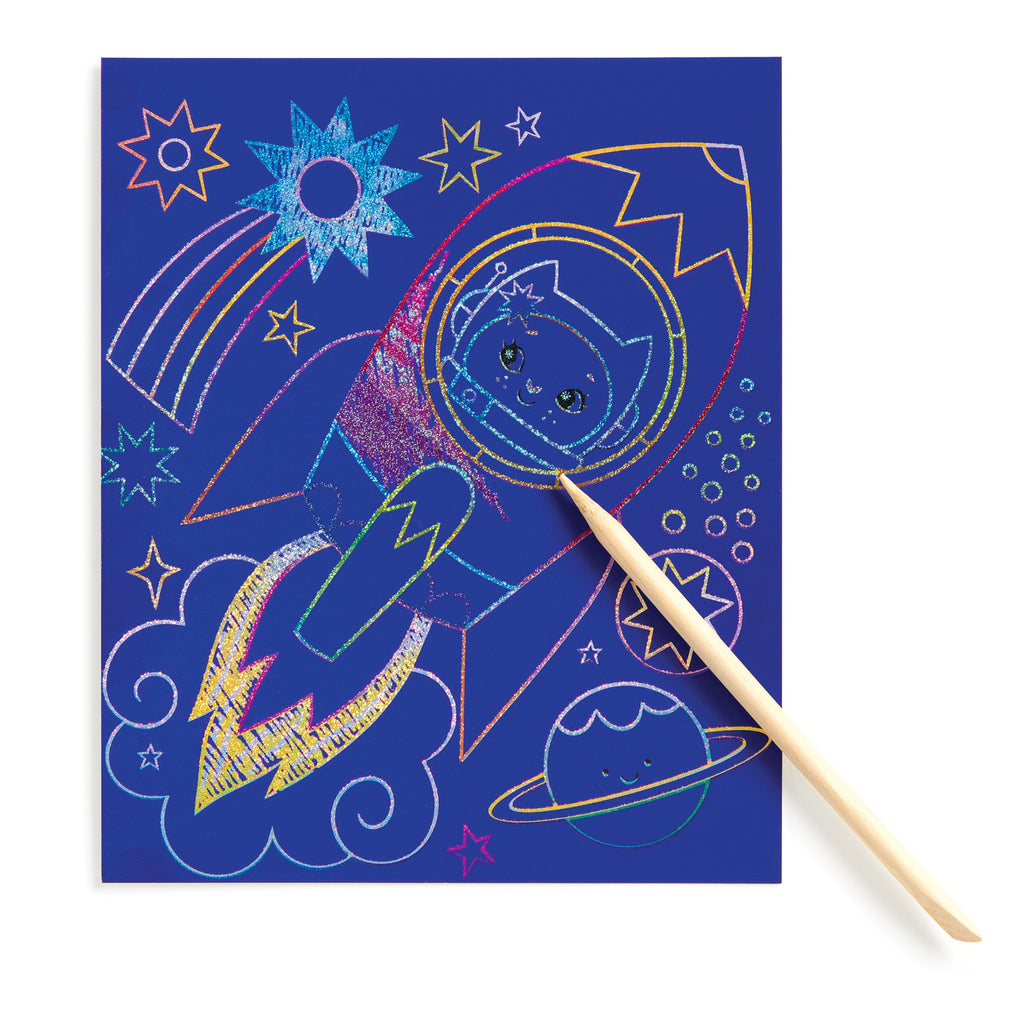 Katie Woods Cosmic Galaxy Scratch Magic features a vibrant cat in a rocket, with stars, a rainbow, planet, and clouds. A wooden stylus reveals the artwork set against a dark blue background, capturing the wonder of space scenes.