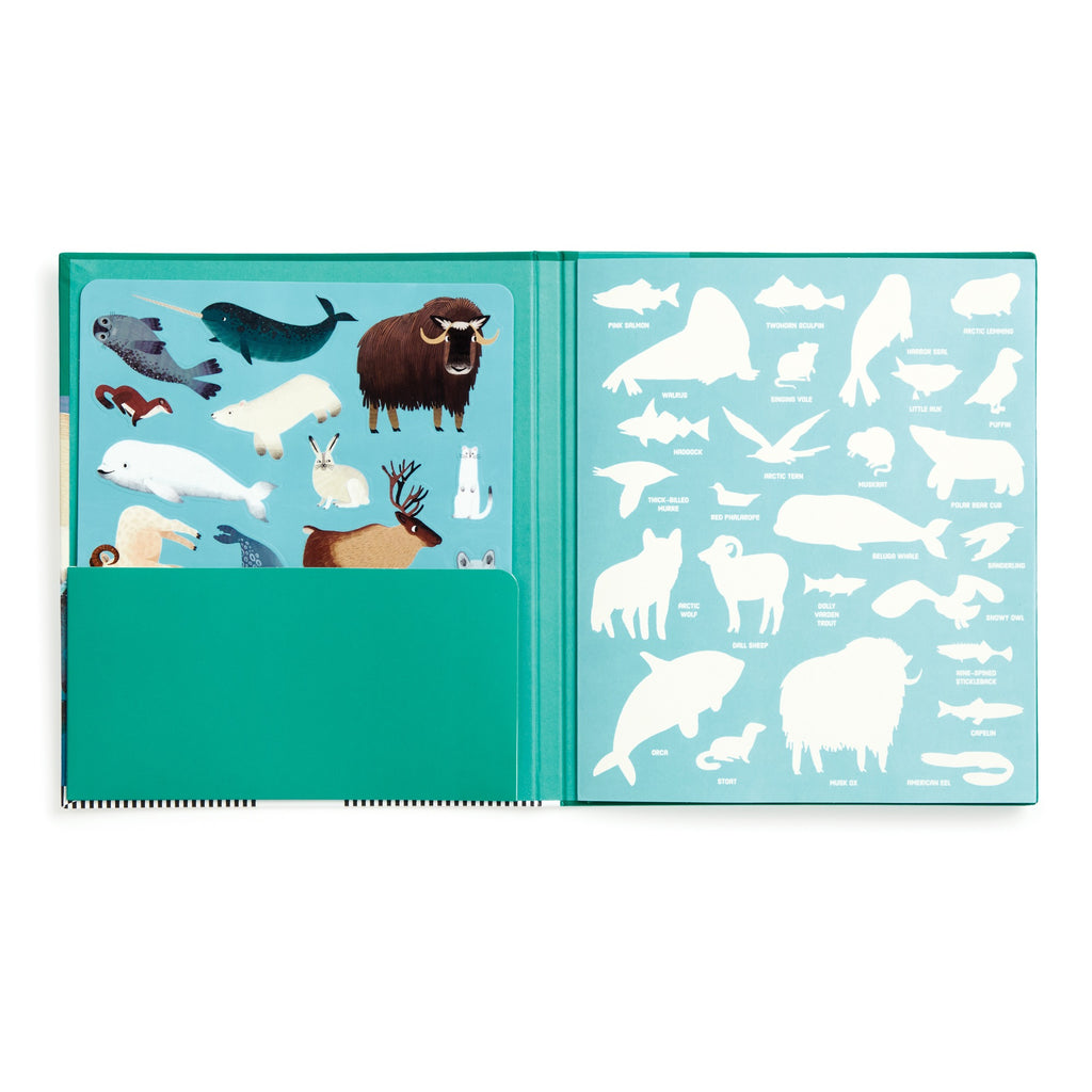 An open book from Hannah Abbo’s Arctic Life Sticker Play Reusable Activity Set shows Arctic animal stickers—seal, narwhal, musk ox, hare, and beluga whale—on the left and matching white silhouettes on the right. A teal pocket holds the sticker sheet.