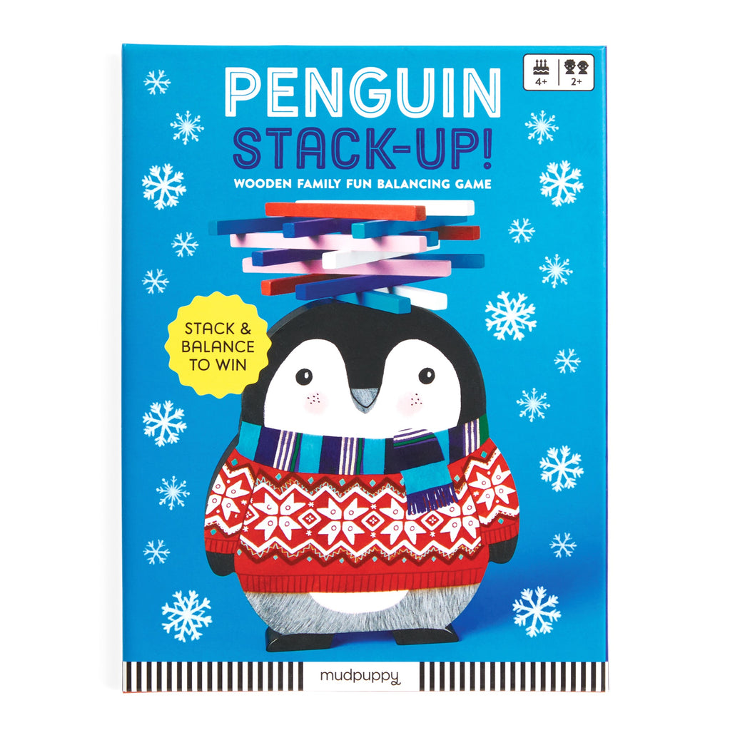 A blue game box from Rebecca Jones shows a cute penguin in a red sweater and scarf balancing colored wooden sticks. The box reads Penguin Stack-up Wooden Balancing Game and features snowflakes in the background.