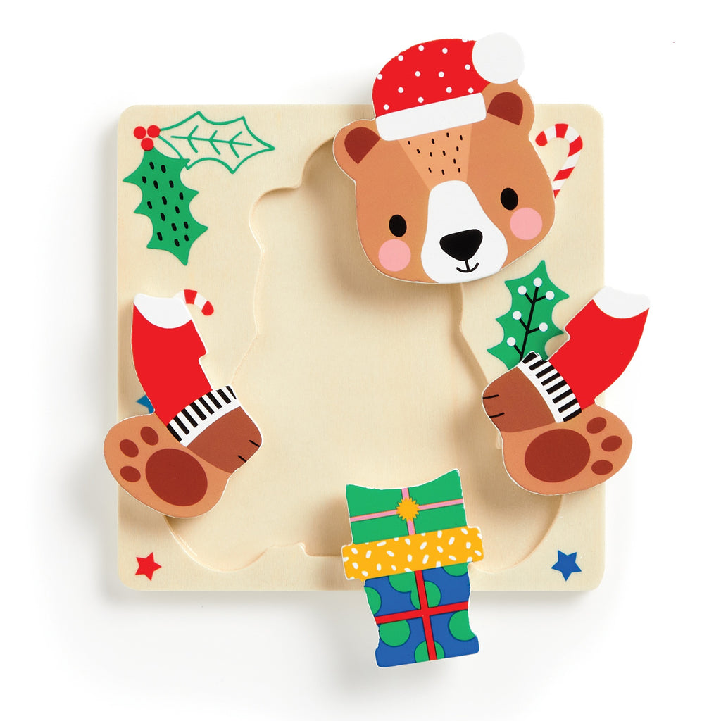 The Wendy Kendall Festive Friends Set of 4 Wood Puzzles features a bear with a Santa hat, two red-mittened paws, holly leaves, a candy cane, and a green gift on a starry square base—perfect for holiday fun.