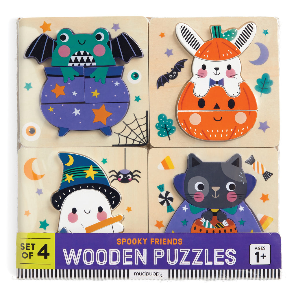 Wendy Kendalls Spooky Friends Set of 4 Wood Puzzles features colorful wood puzzles with a frog in a cauldron, ghost with pumpkin, witch, and black cat. Durable wood construction. For ages 1+.